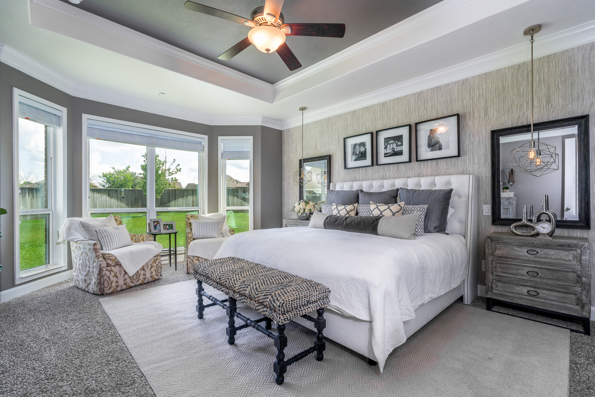 master bedroom. transitional, transitional bedroom, master suite. wallpaper, bedroom, windows, accent chairs, lumbar, dresser, nightstands, bedroom bench, area rug, neutral bedroom, white bedroom, personal, pendant lights over night stand