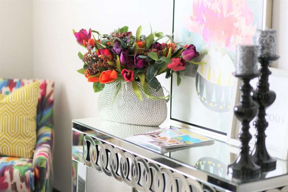 feminine guestroom, girl guestroom, guestroom, boutique style guest room, colorful guestroom, accent chair in guest room, black bed, wooden bed, floor mirror, textured bedding, guest bedroom decor