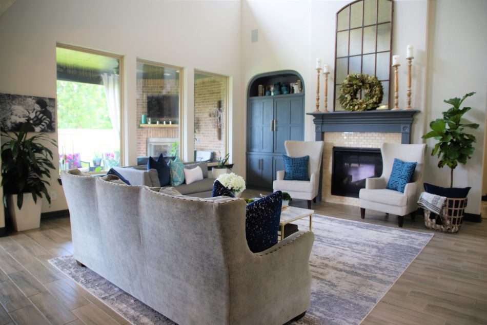 living room decor, living room colors, blue living room, gray sofa, bar stools at island. ivory kitchen, summer decor, blue summer decor, summer living room, colorful living room, coffee table, marble coffee table, coffee table decor, hydrangeas, blue vases, built ins, living room built ins, display box, living room pillows, blue pillows, navy pillows