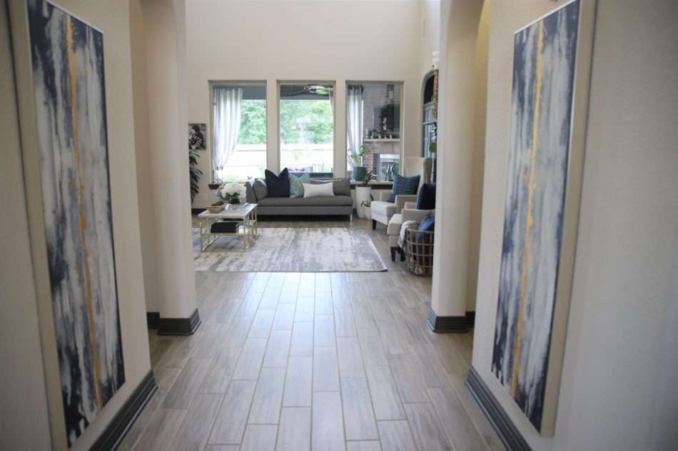 living room decor, living room colors, blue living room, gray sofa, bar stools at island. ivory kitchen, summer decor, blue summer decor, summer living room, colorful living room, coffee table, marble coffee table, coffee table decor, hydrangeas, blue vases, built ins, living room built ins, display box, living room pillows, blue pillows, navy pillows