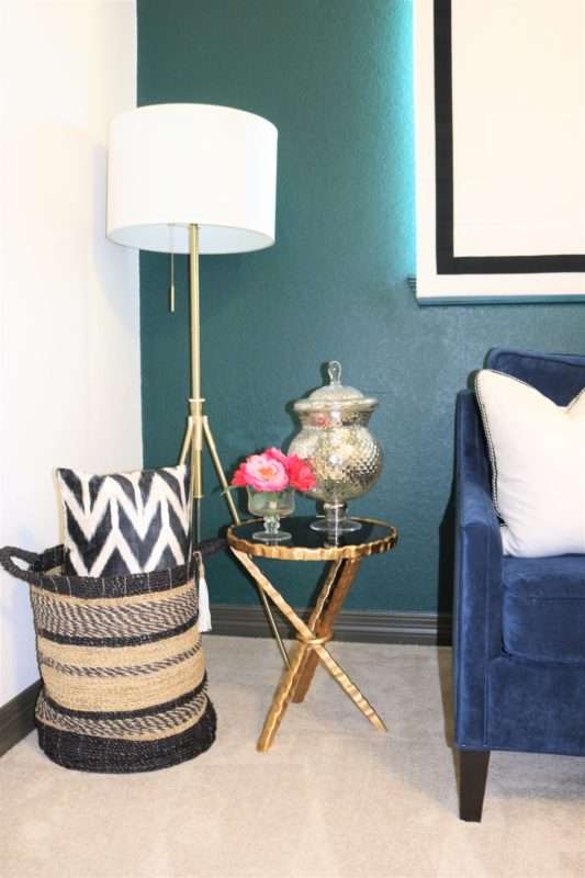 table books, books on coffee table, books on table, coffee table decor, how to accessorize like a pro, boxwood on table, mixing materials, coffee table accessories, accessorizing, how to accessorize, how to layer books, how to decorate like a pro, how to decorate with books, display case, agate stone, agate stone in display case, decorating in odd numbers, the rules of three, how to decorate in odd numbers, living room decor, mirrored credenza, balanced living room, luxury living room, mixed materials, vignette, floor lamp, brass floor lamp, navy sofa, navy sofa with chaise, pillow in basket, black basket,