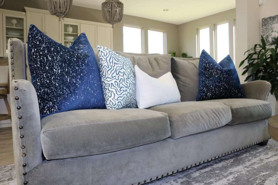 living room decor, living room colors, blue living room, gray sofa, bar stools at island. ivory kitchen, summer decor, blue summer decor, summer living room, colorful living room, coffee table, marble coffee table, coffee table decor, hydrangeas, blue vases, built ins, living room built ins, display box, living room pillows, blue pillows, navy pillows, summer decor