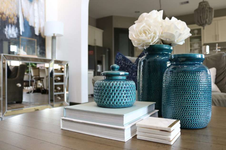 blue accessories, blue decor, living room with blue decor, gray sofa, living room decor, living room, neutral living room, pops of blue, blue colors in living room, blue pillows, blue vases, wooden coffee table