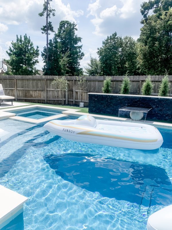 modern patio, modern outdoor furniture, modern patio decor, modern pool design, contemporary pool design, contemporary patio, fall patio decor, modern furnished patio, modern pool. black and white patio, black and white outdoor rug, outdoor sofa, outdoor chaise lounges, styled patio, styled pool, styled chaise lounges, towel rack, pool towels, towels by the pool, pool towel storage, pool storage solutions, outdoor dining, dining table, outdoor dining table, outdoor chandelier, patio dining table, outdoor planters, modern planters, over-sized floats, pool floats, unique pool floats