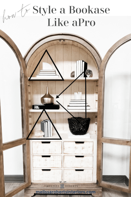 MRI, Melissa Roberts Interiors, Houston Interior Design, Houston Interior Designers, Arched Cabinet, Bookcase, Styling a Cabinet, Styling a Bookcase, Book Shelf, Styling a Bookshelf, How Interior Designer Style a bookcase, Modern, Modern Styled shelf, Style a Bookcase Like a pro, styling a cabinet with books, staging a bookcase, staging, how to stage a home, home décor, home décor ideas, bookcase hack, styling hacks, updating old bookcase, before and after, how to decorate a bookcase, how to decorate a cabinet, modern styling, organic home décor, neutral color tones, neutral color tones home décor, floating shelf, etagere