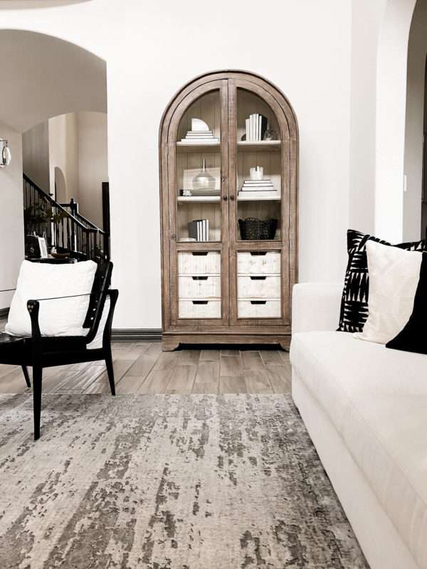 MRI, Melissa Roberts Interiors, Houston Interior Design, Houston Interior Designers, Arched Cabinet, Bookcase, Styling a Cabinet, Styling a Bookcase, Book Shelf, Styling a Bookshelf, How Interior Designer Style a bookcase, Modern, Modern Styled shelf, Style a Bookcase Like a pro, styling a cabinet with books, staging a bookcase, staging, how to stage a home, home décor, home décor ideas, bookcase hack, styling hacks, updating old bookcase, before and after, how to decorate a bookcase, how to decorate a cabinet, modern styling, organic home décor, neutral color tones, neutral color tones home décor, floating shelf, etagere